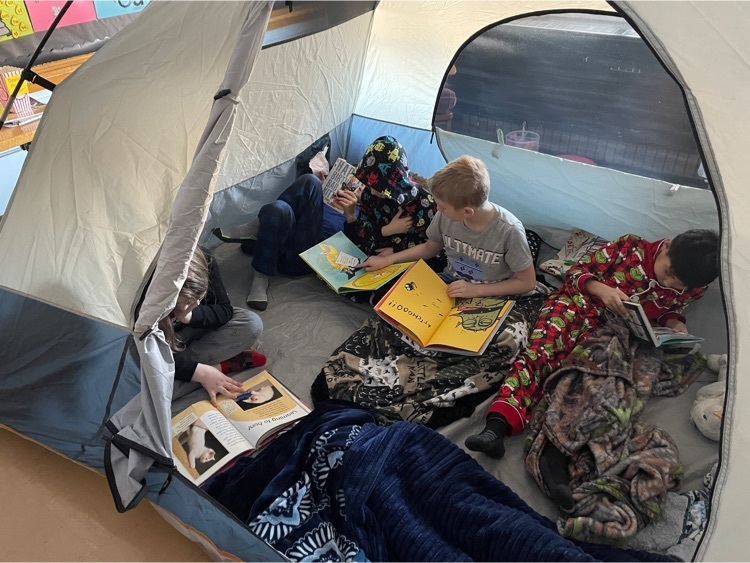 second graders reading in their tent