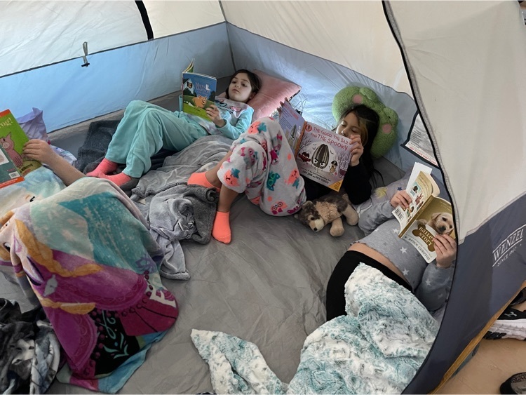 second graders reading in their tent