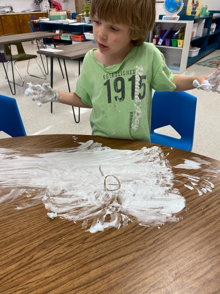 first grader writing with shaving cream
