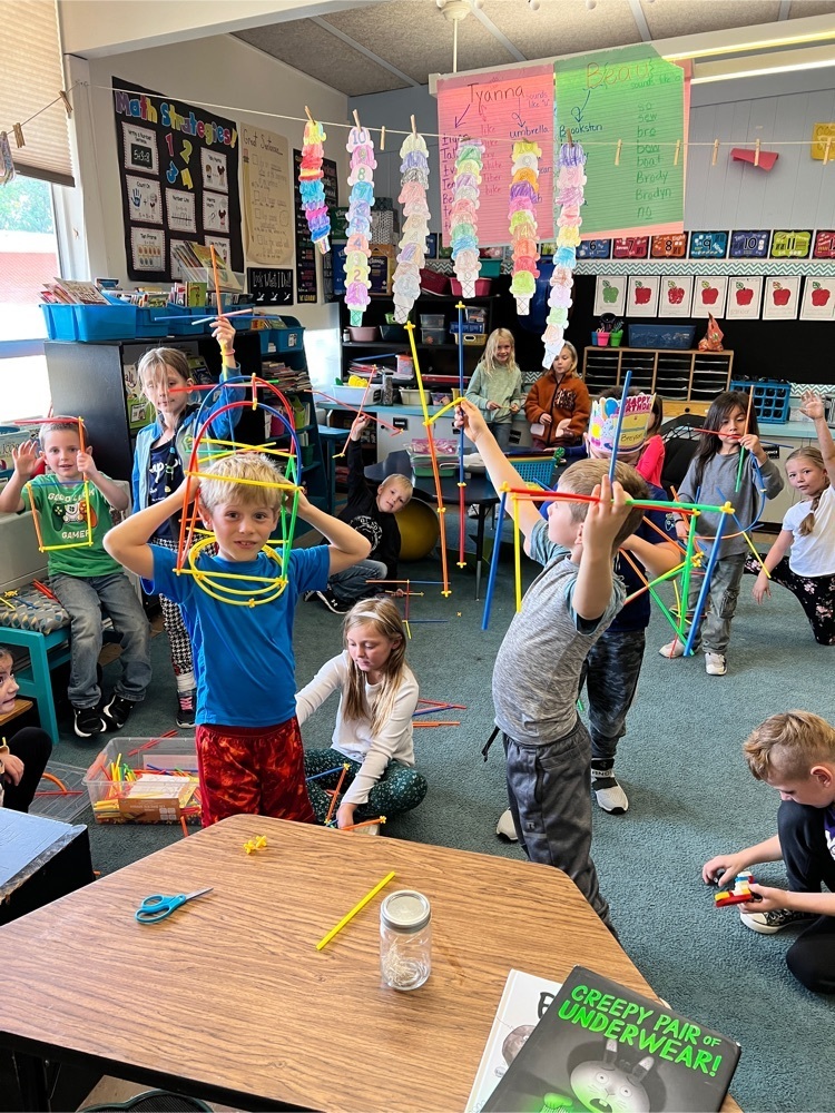 first graders holding up their creations